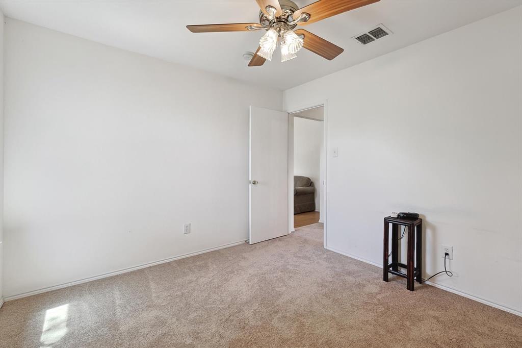 5424 Elk Ridge Drive Watauga, TX 76137 - Photo 30 of 40 an empty room with windows and fan