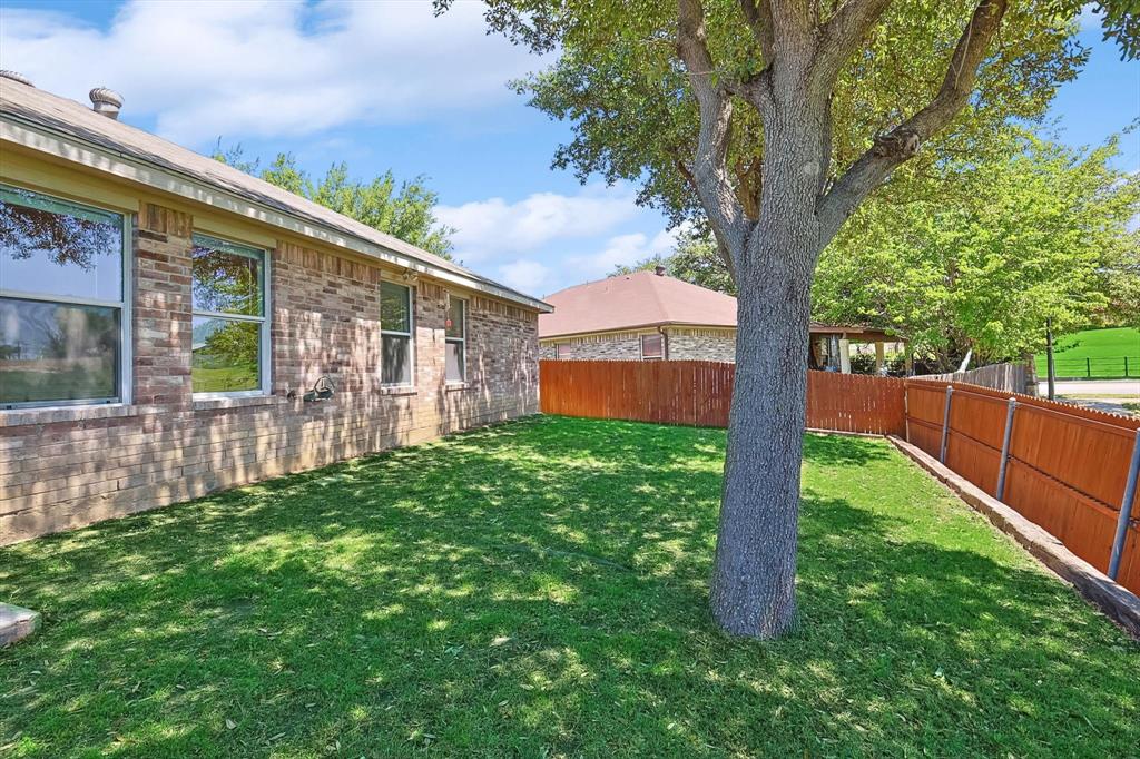 5424 Elk Ridge Drive Watauga, TX 76137 - Photo 32 of 40 a front view of a house with a yard