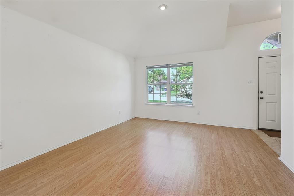 5424 Elk Ridge Drive Watauga, TX 76137 - Photo 4 of 40 an empty room with wooden floor and windows