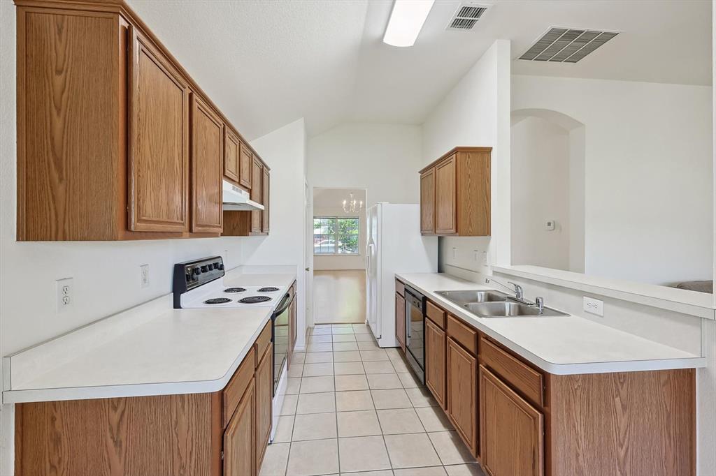 5424 Elk Ridge Drive Watauga, TX 76137 - Photo 9 of 40 a kitchen with a sink stove top oven and cabinets