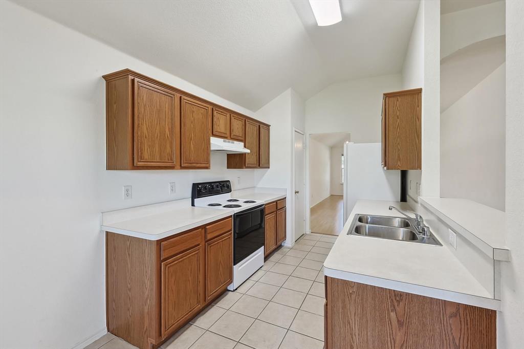 5424 Elk Ridge Drive Watauga, TX 76137 - Photo 10 of 40 a kitchen with a sink stove and cabinets