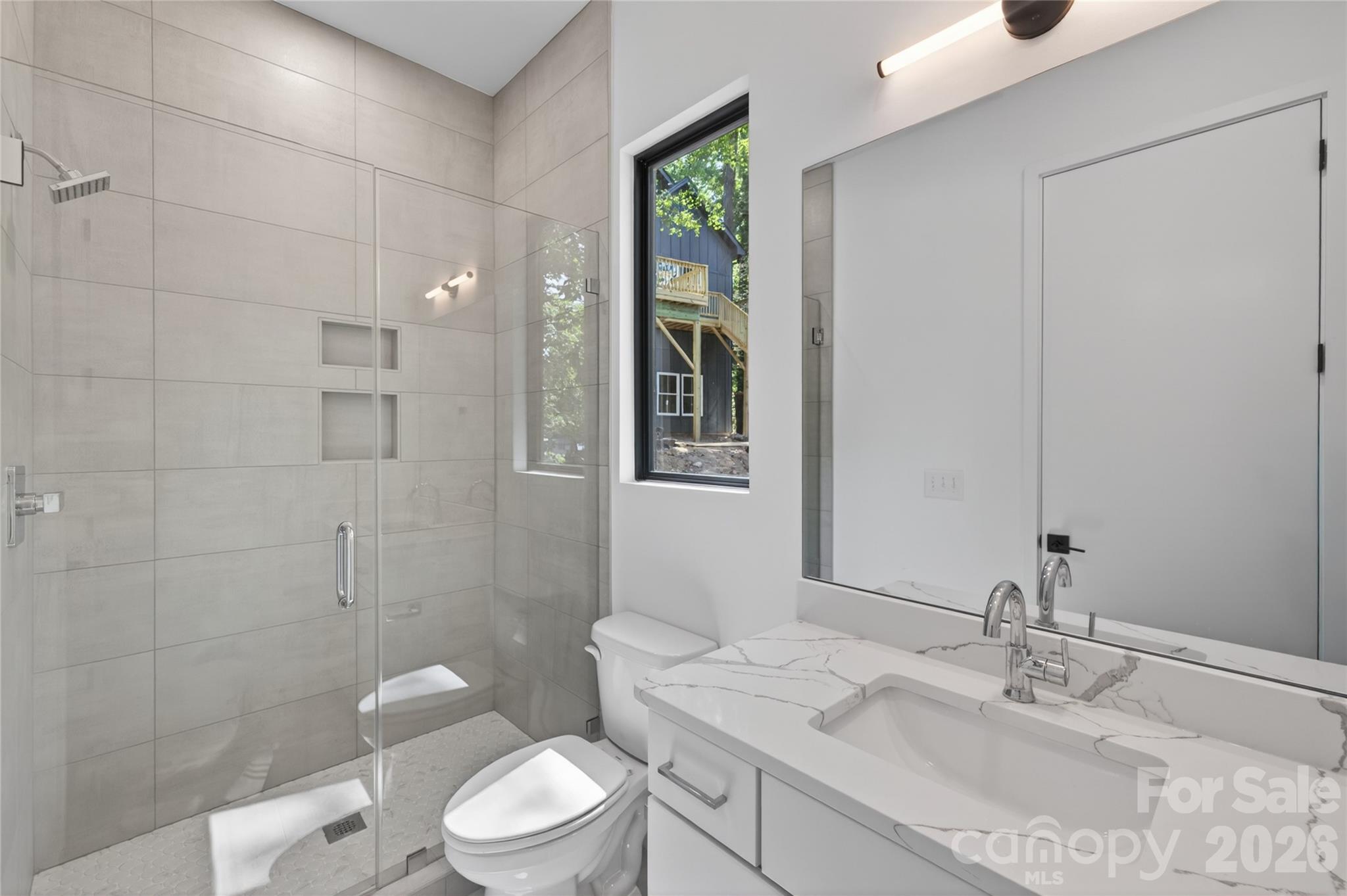 115 High Shores Road Norwood, NC 28128 - Photo 22 of 30 a bathroom with a granite countertop sink a toilet and a mirror