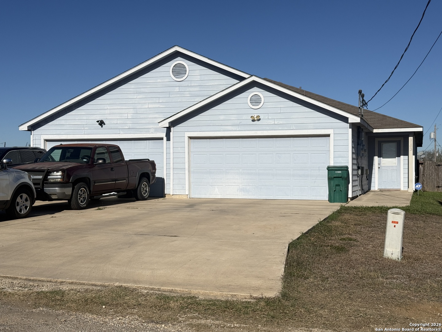 1103 Maple Street Jourdanton, TX 78026 - Photo 2 of 11 a front view of a house with cars parked