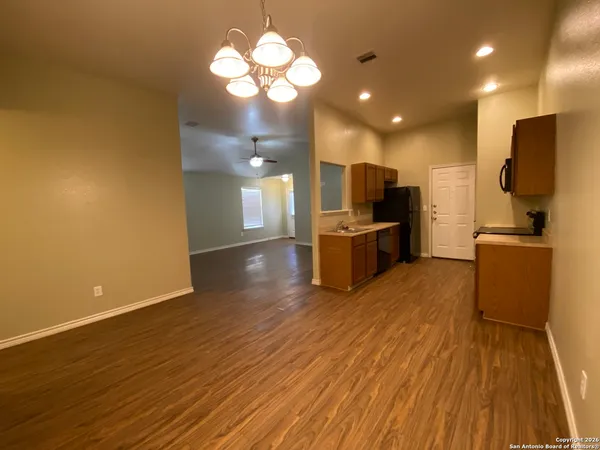 a view of a kitchen with a sink and a refrigerator
