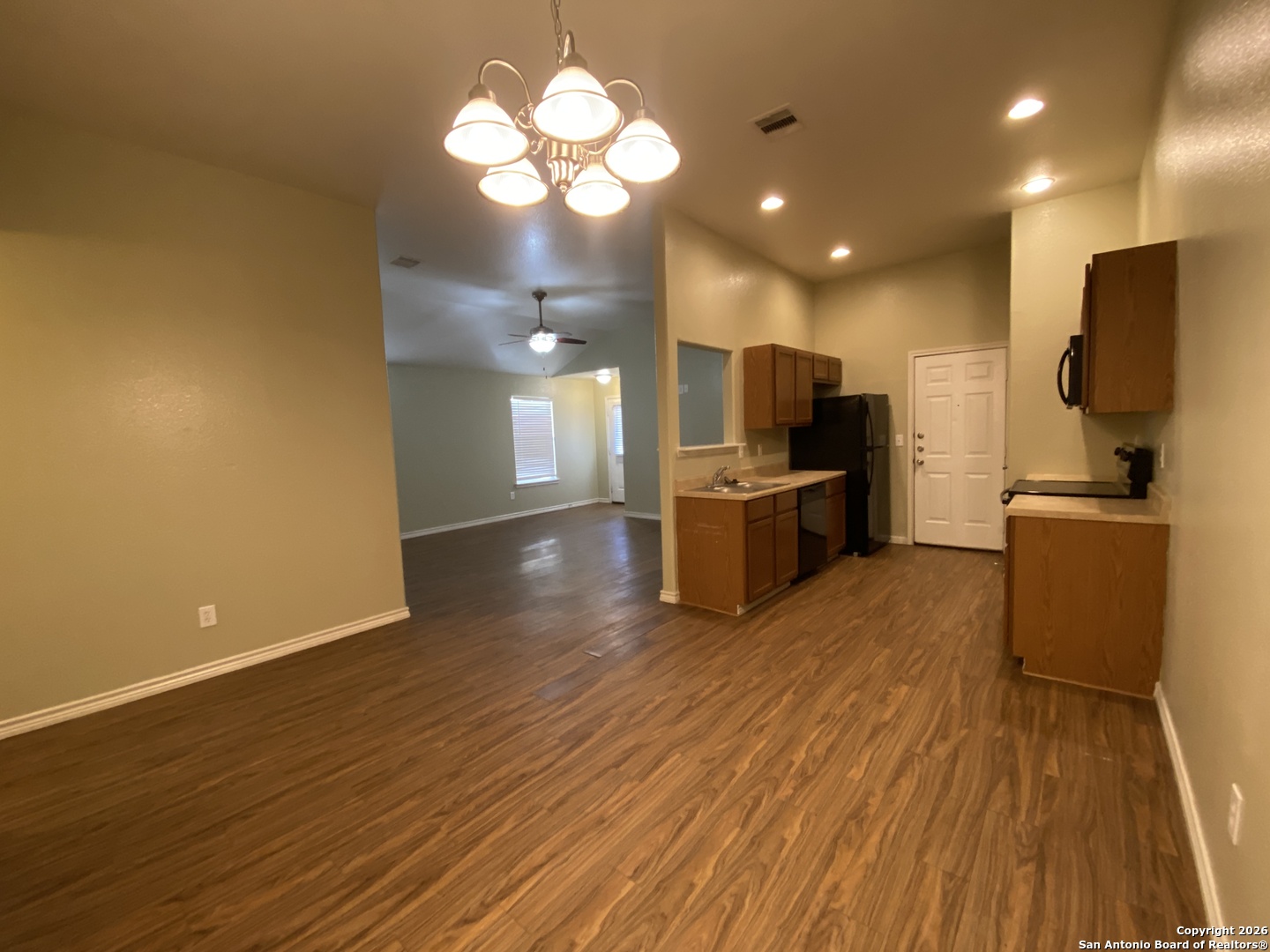 1103 Maple Street Jourdanton, TX 78026 - Photo 3 of 11 a view of a kitchen with a sink and a refrigerator