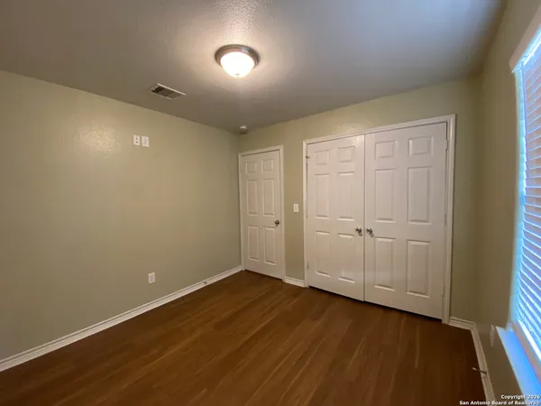 a view of a room with wooden floor