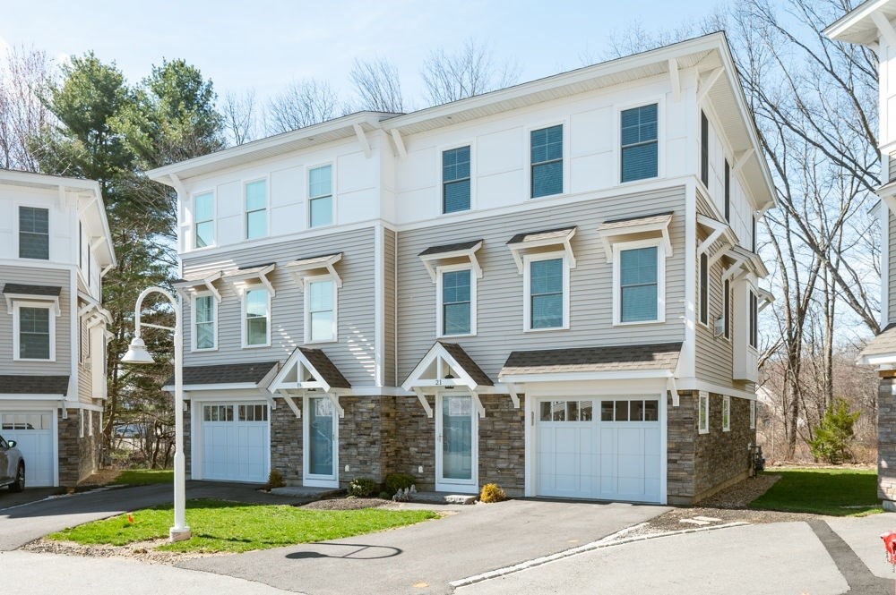 21 Hines Way, Unit 21 Newburyport, MA 01950 - Photo 1 of 21 a front view of a house with a garden and plants