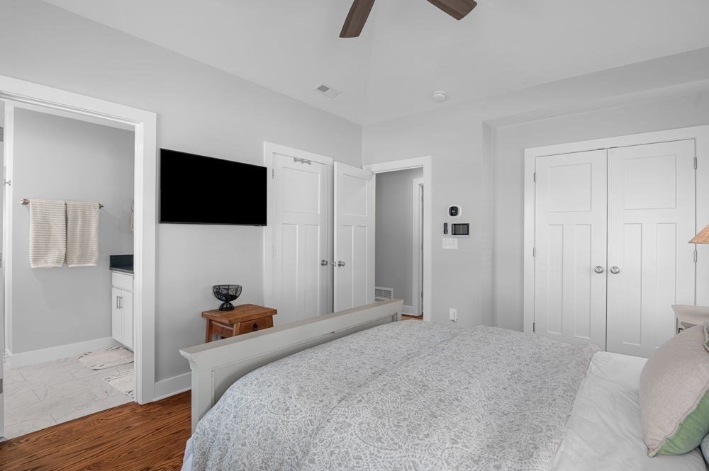 21 Hines Way, Unit 21 Newburyport, MA 01950 - Photo 11 of 21 a bedroom with a bed a flat tv screen and a wooden floor