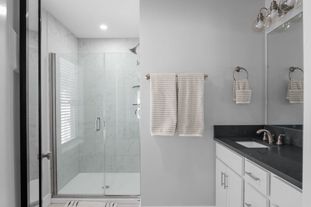 21 Hines Way, Unit 21 Newburyport, MA 01950 - Photo 13 of 21 a bathroom with a shower sink and mirror
