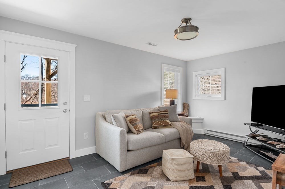 21 Hines Way, Unit 21 Newburyport, MA 01950 - Photo 19 of 21 a living room with furniture and a flat screen tv