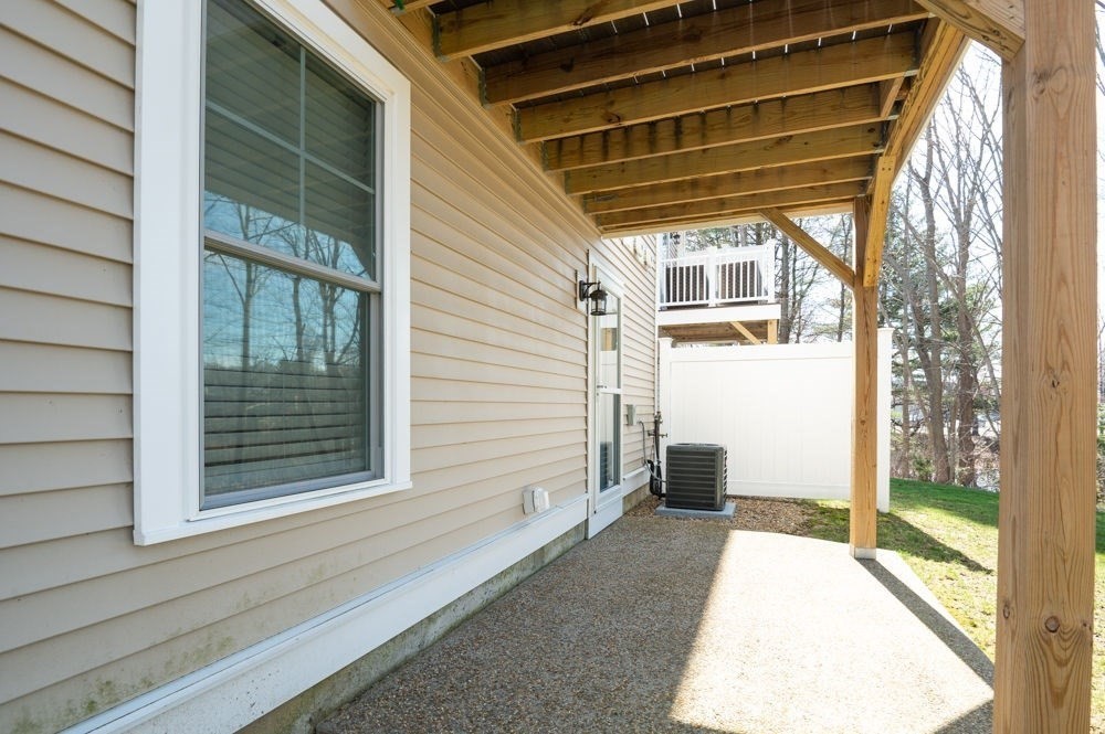 21 Hines Way, Unit 21 Newburyport, MA 01950 - Photo 20 of 21 a view of a porch with a table and chairs