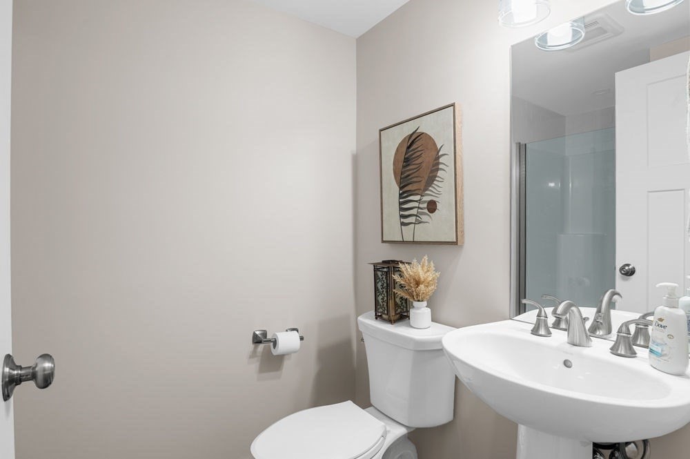 21 Hines Way, Unit 21 Newburyport, MA 01950 - Photo 21 of 21 a bathroom with a toilet a sink and mirror