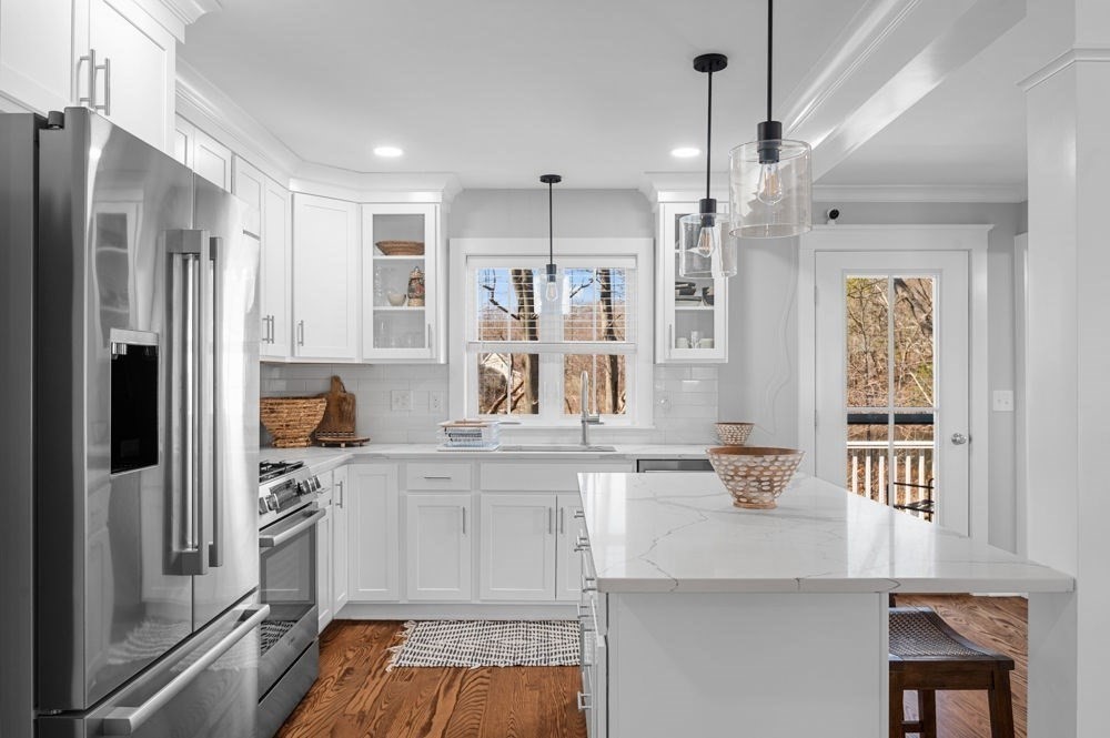 21 Hines Way, Unit 21 Newburyport, MA 01950 - Photo 5 of 21 a kitchen with white cabinets and refrigerator