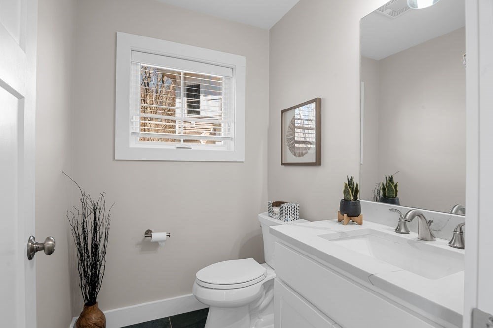21 Hines Way, Unit 21 Newburyport, MA 01950 - Photo 9 of 21 a bathroom with a toilet sink and mirror