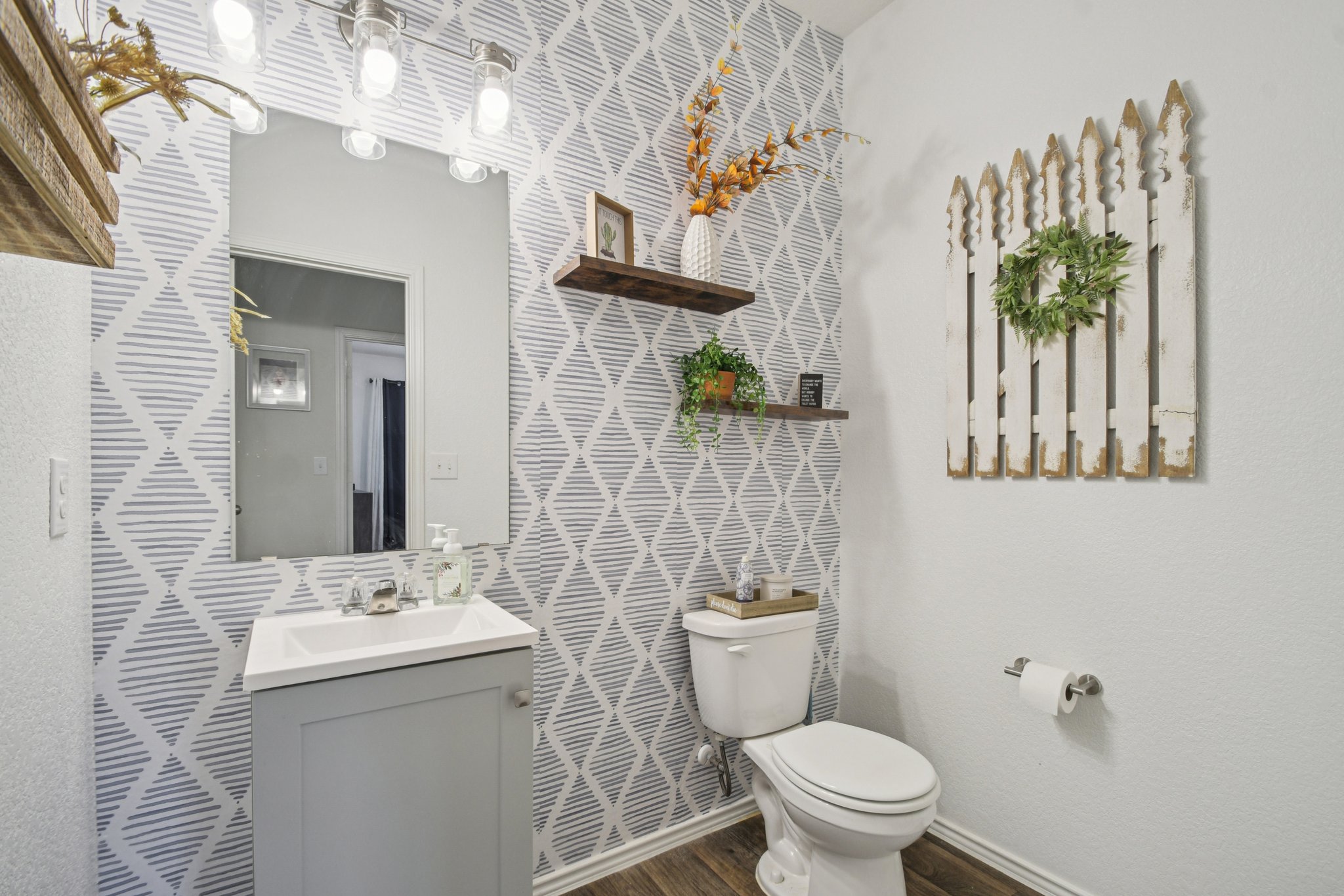 14904 Shalestone Way Manor, TX 78653 - Photo 8 of 23 Half bath (downstairs) featuring vanity and dark wood-type flooring