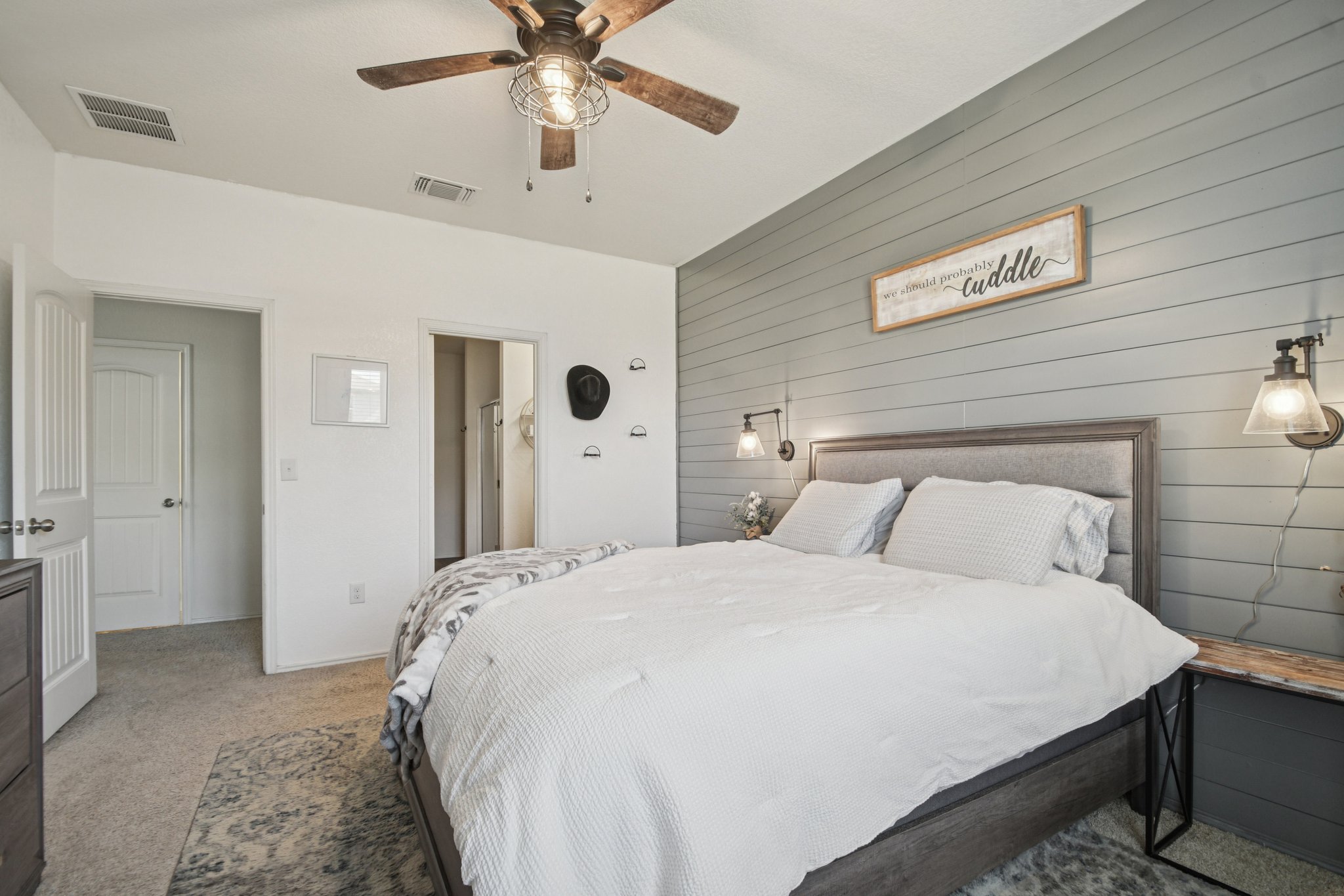 14904 Shalestone Way Manor, TX 78653 - Photo 10 of 23 Bedroom with wood walls, light colored carpet, and a ceiling fan
