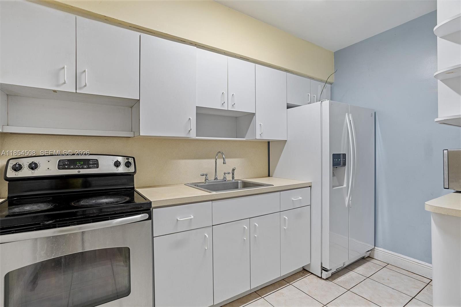 1701 Southwest 21st Street Miami, FL 33145 - Photo 14 of 28 a kitchen with a stove and a refrigerator