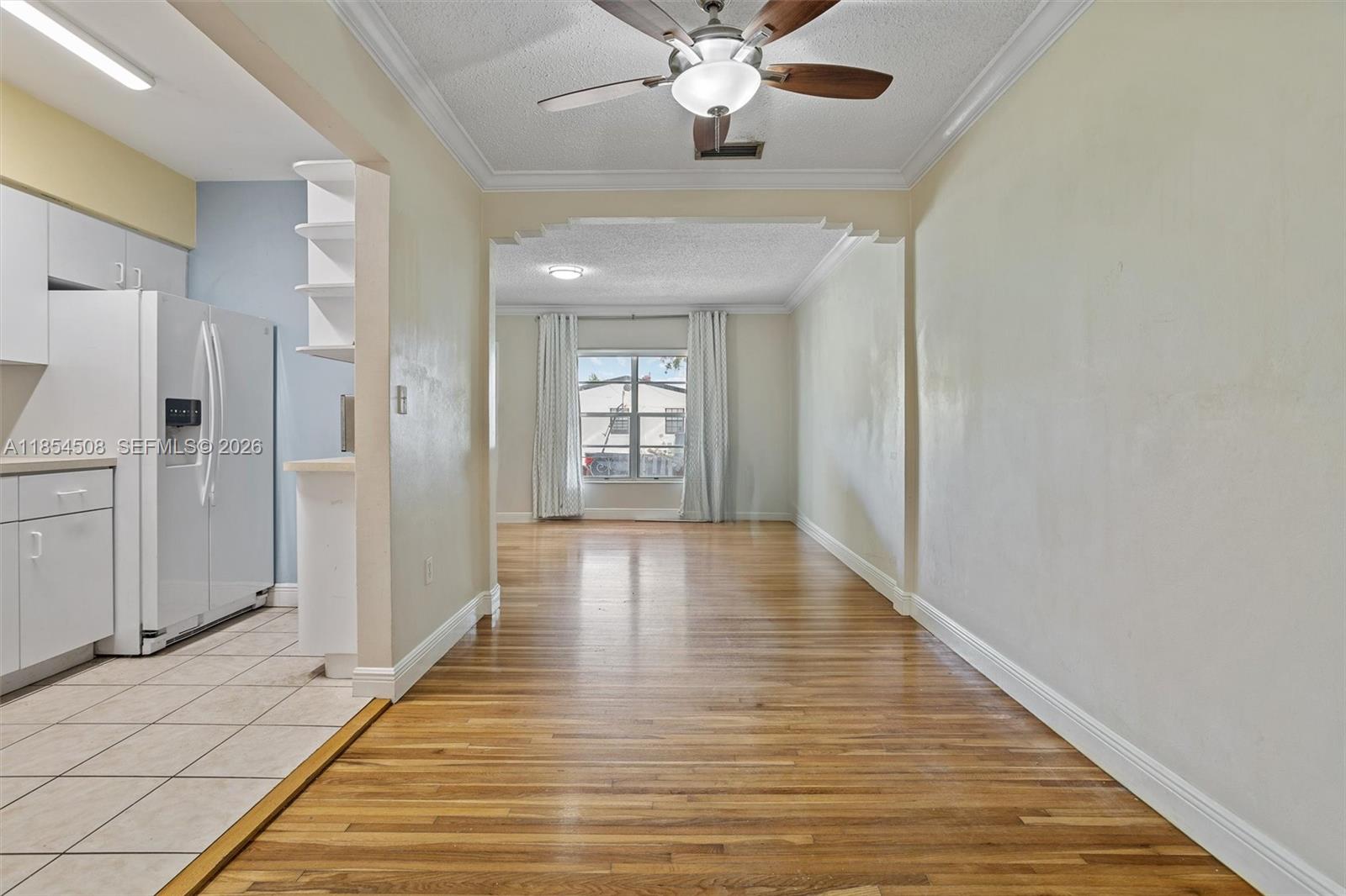 1701 Southwest 21st Street Miami, FL 33145 - Photo 16 of 28 a view of an empty room with wooden floor and a window