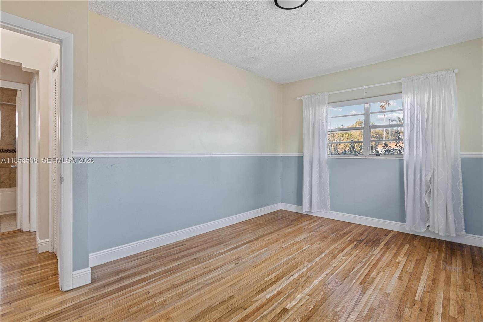 1701 Southwest 21st Street Miami, FL 33145 - Photo 22 of 28 an empty room with wooden floor and windows