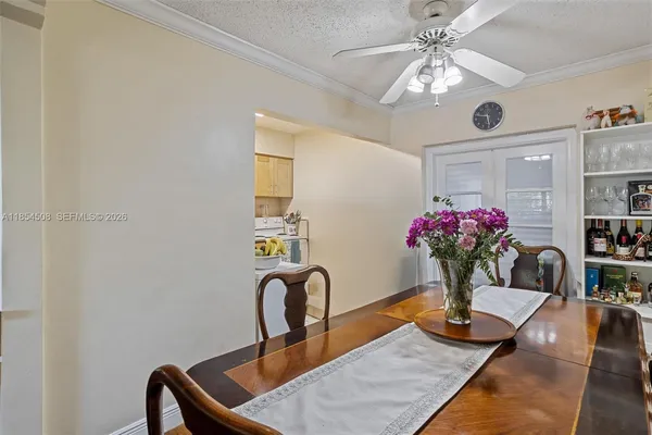 a view of a dining room with furniture and a chandelier