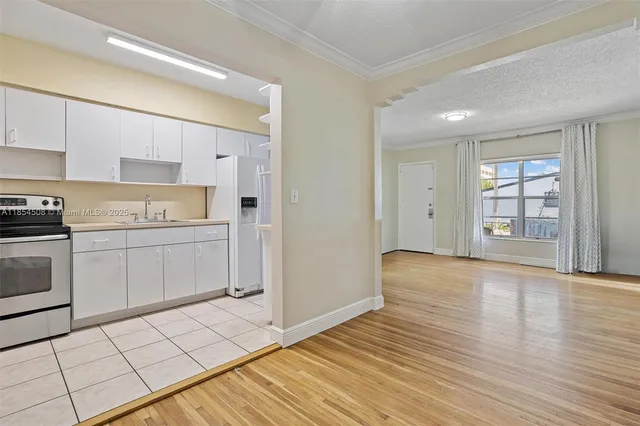 a view of a kitchen with dishwasher and wooden floor