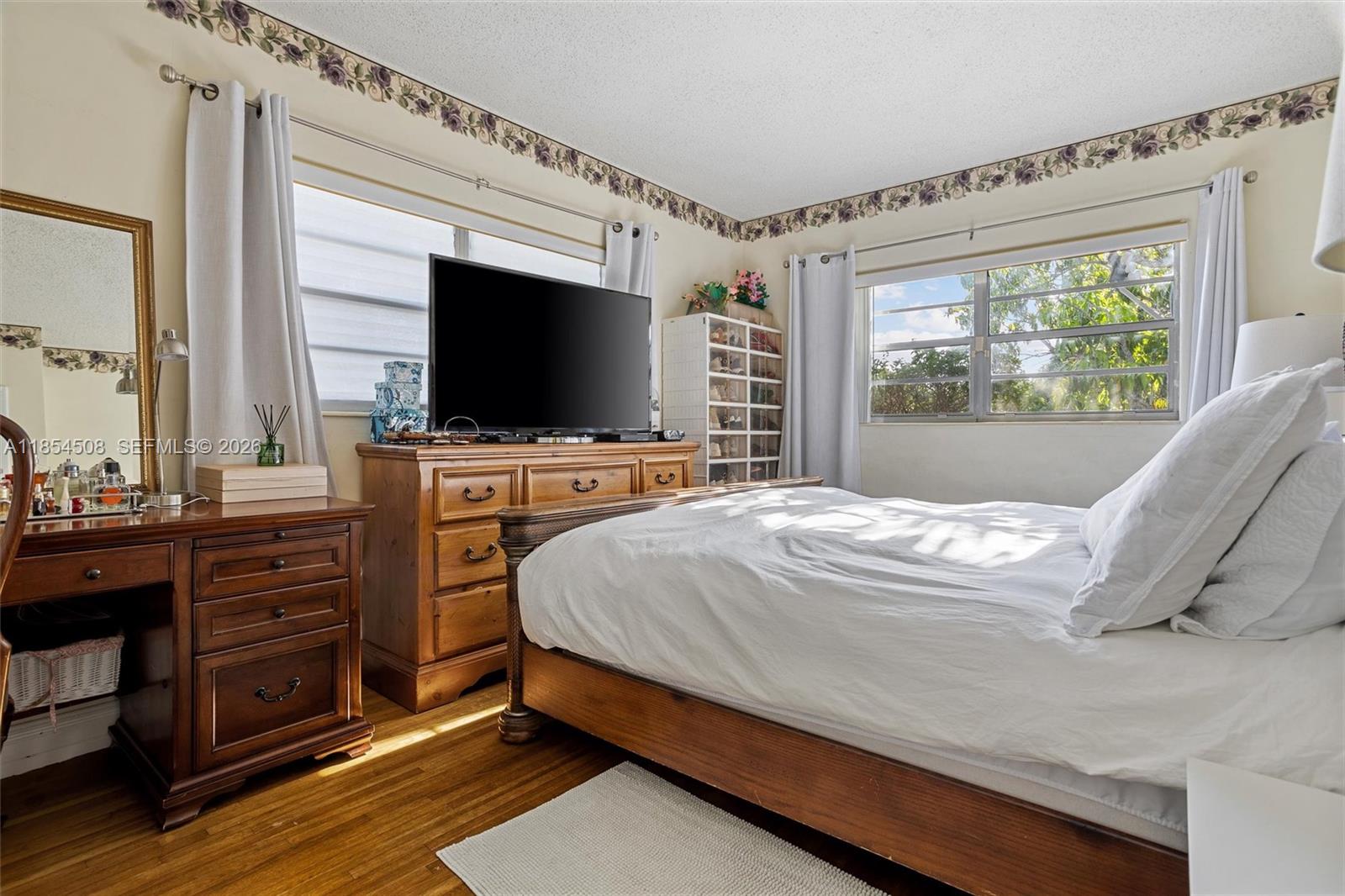 1701 Southwest 21st Street Miami, FL 33145 - Photo 9 of 28 a bedroom with a bed and a flat tv screen on dresser