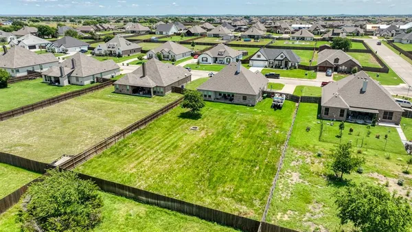 an aerial view of a house with a garden and houses