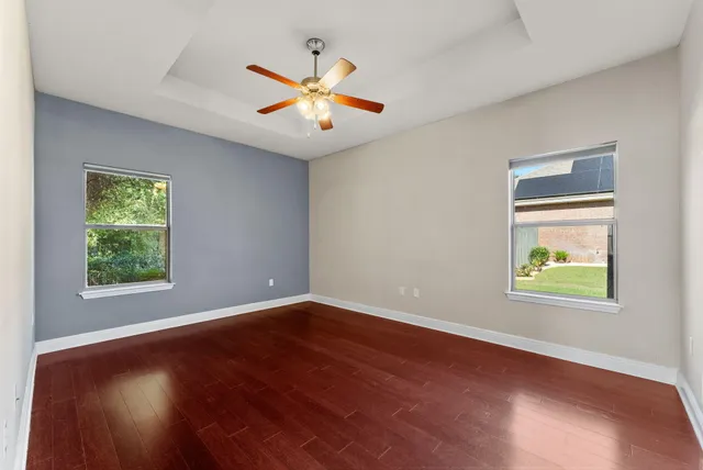a view of an empty room with wooden floor
