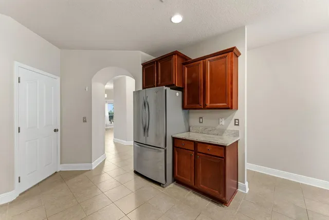 a kitchen with stainless steel appliances granite countertop a refrigerator and a sink