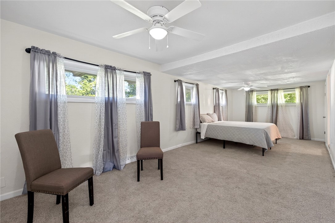 2684 Arthur Road Springfield, OH 45502 - Photo 26 of 69 This spacious bedroom offers ample natural light and comfortable carpeting, creating a serene personal retreat.