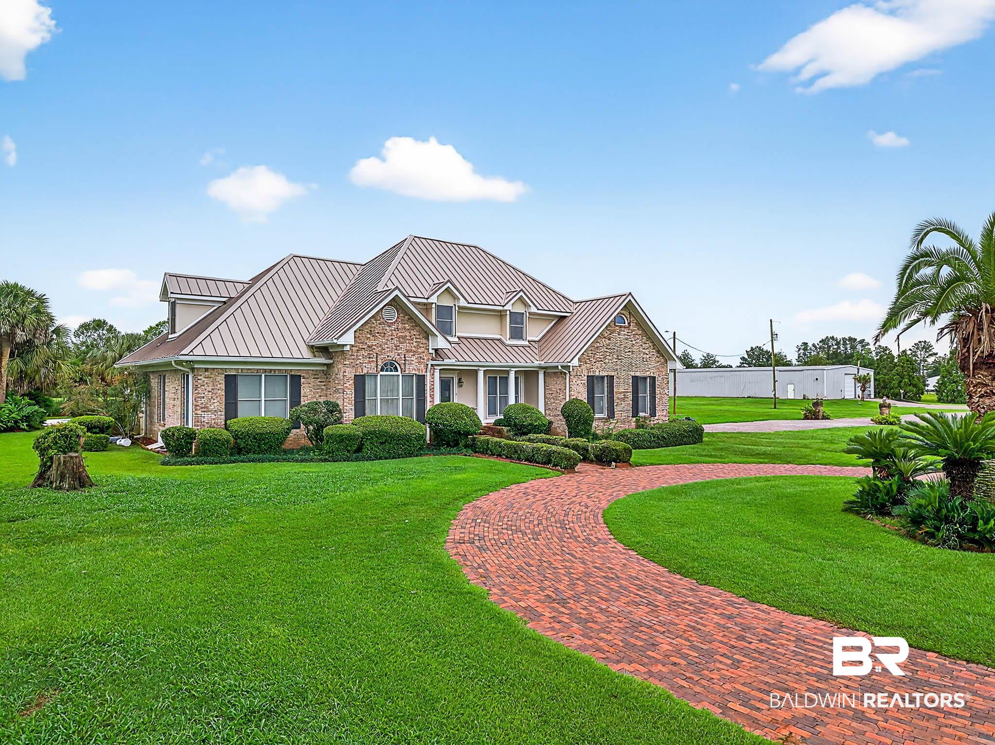 17270 Davis Road Summerdale, AL 36580 - Photo 63 of 97 View of front of property featuring a standing seam roof, a front yard, and a metal roof
