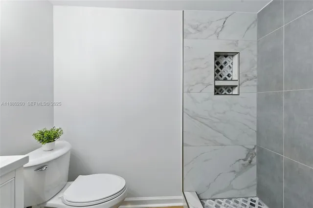 a white toilet sitting next to a shower curtain