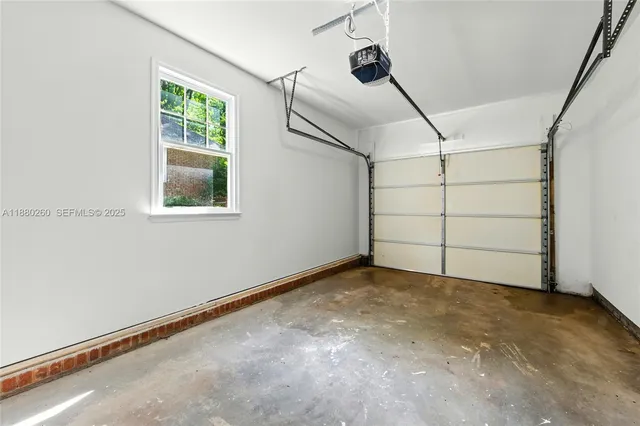 an empty room with windows and ceiling fan