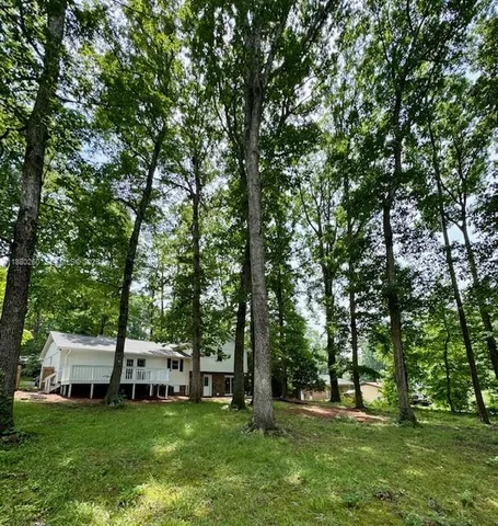 a view of a house with a backyard