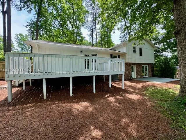 a view of a house with a yard and deck