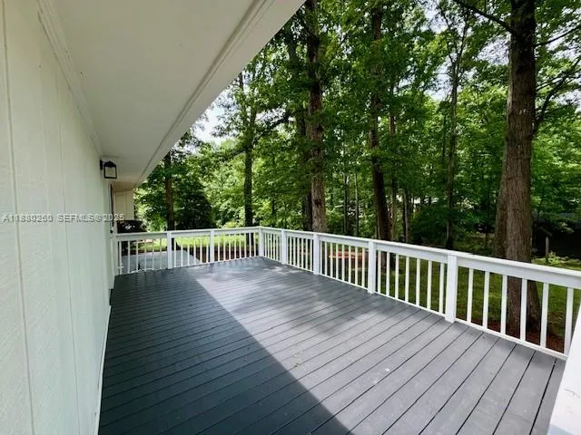 a view of balcony with deck and wooden floor