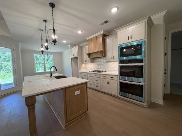 210 Drake Drive Collierville, TN 38017 - Photo 6 of 19 a kitchen with kitchen island a sink stainless steel appliances and cabinets