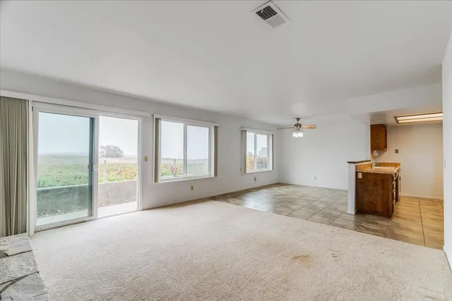 a room with pool table and windows