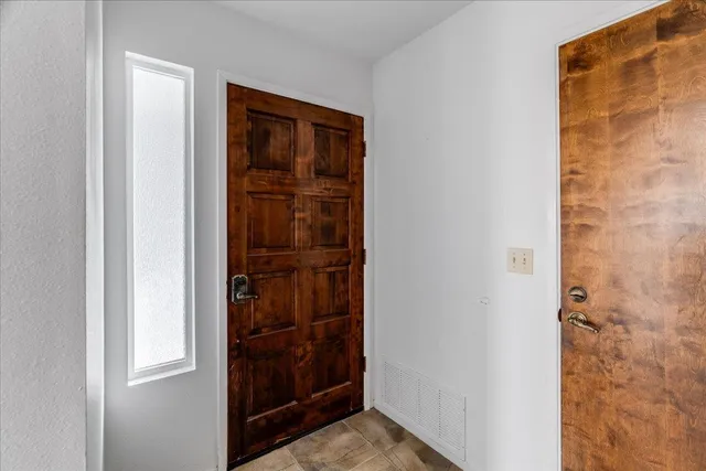 a view of an empty room with a fireplace and a floor to ceiling window