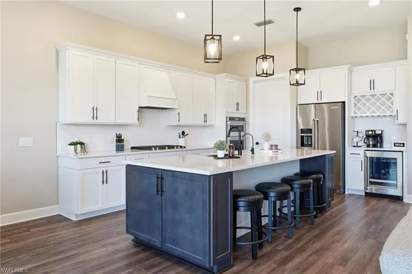 a kitchen with refrigerator cabinets and wooden floor