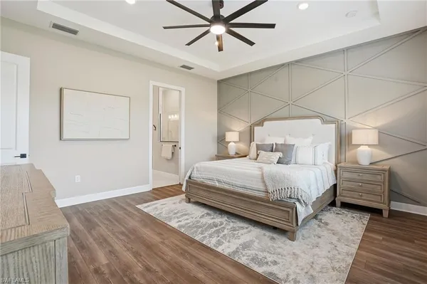 a bedroom with a bed and a chandelier