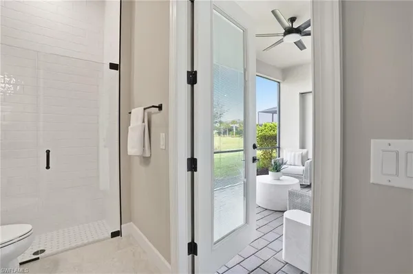 a bathroom with a toilet and a shower