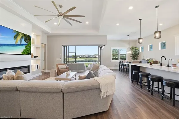 a living room with furniture wooden floor and a flat screen tv