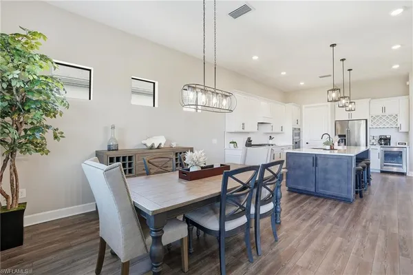 a dining room with furniture and wooden floor