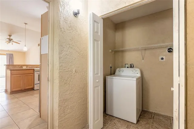 a utility room with cabinets washer and dryer