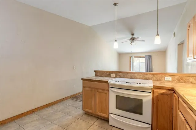 a view of a kitchen with a stove cabinets and a wooden floor