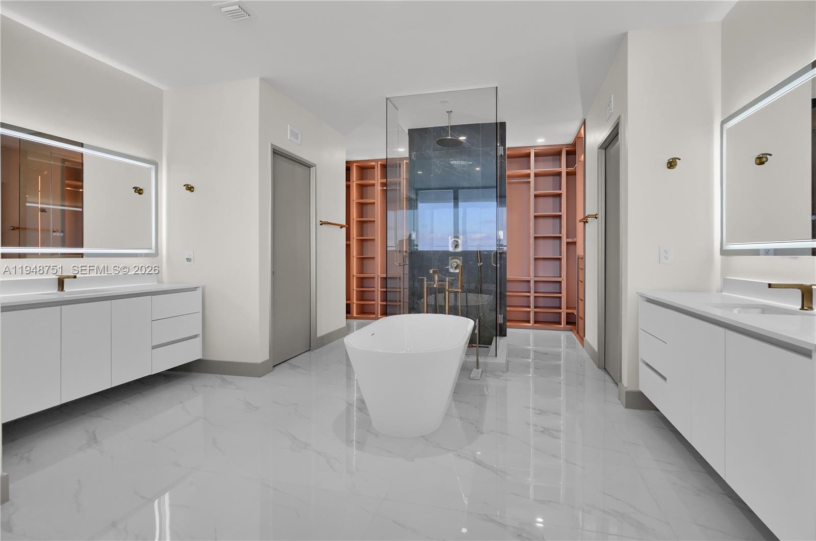 700 Northeast 24th Street, Unit PH5801 Miami, FL 33137 - Photo 29 of 81 a spacious bathroom with a double vanity sink a large mirror and a bathtub