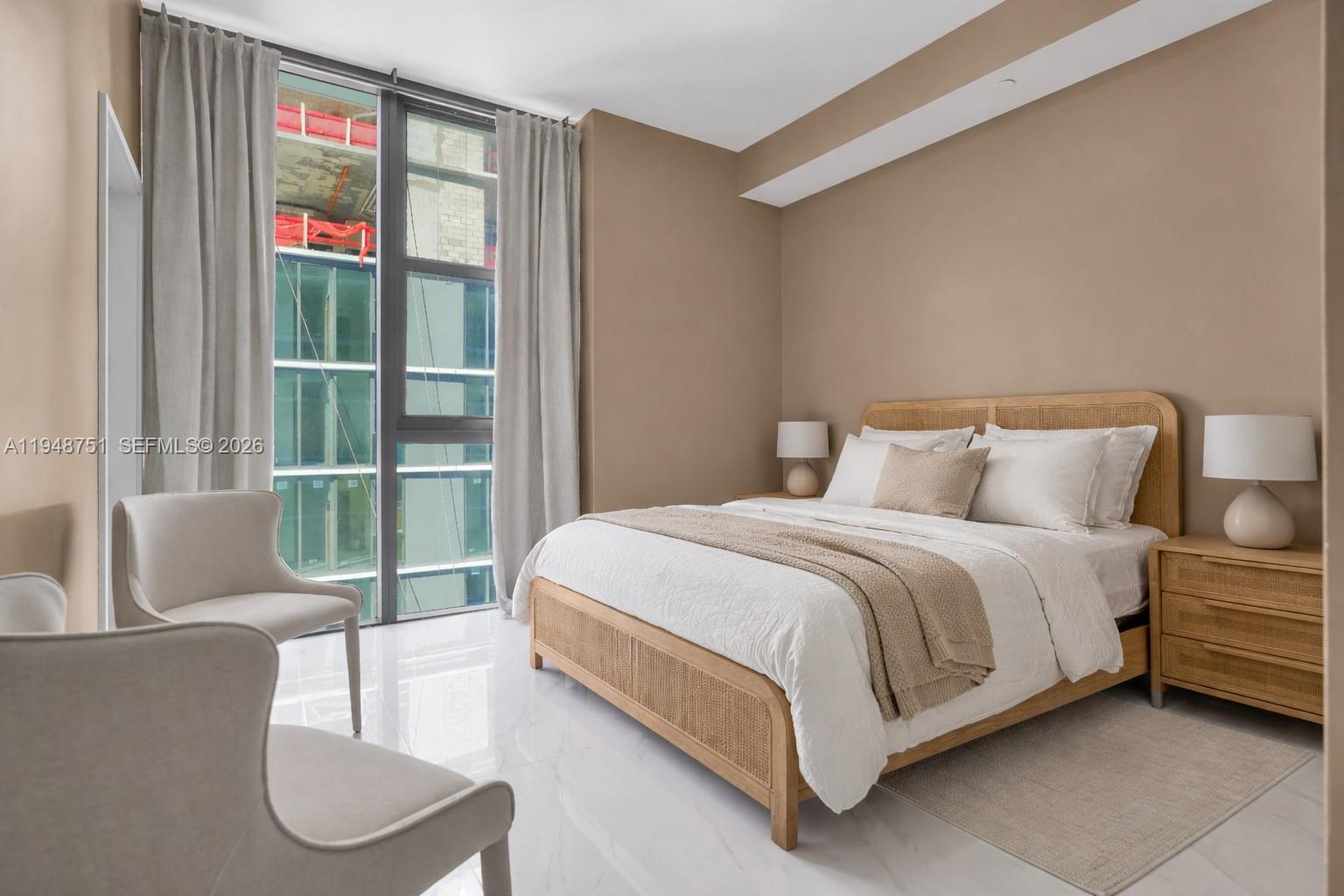 700 Northeast 24th Street, Unit PH5801 Miami, FL 33137 - Photo 30 of 81 a spacious bedroom with a bed a couch and a window