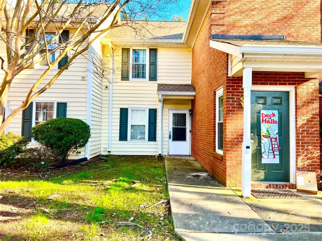 a view of a house with a yard and plants