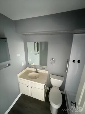 a white toilet sitting next to a bathroom sink